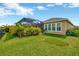 Expansive backyard with lush green grass and views of the screened-in pool area at 5502 Limelight Dr, Apollo Beach, FL 33572