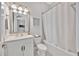 Cozy bathroom featuring a white vanity, tiled bathtub, and light fixtures at 5502 Limelight Dr, Apollo Beach, FL 33572