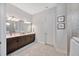 Bathroom with double vanity, dark brown cabinets, and tiled floors at 5502 Limelight Dr, Apollo Beach, FL 33572