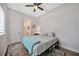 Bright bedroom with a comfy bed, ceiling fan, and access to a private bathroom at 5502 Limelight Dr, Apollo Beach, FL 33572