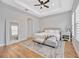 Main bedroom with hardwood floors, ceiling fan, and large mirror at 5502 Limelight Dr, Apollo Beach, FL 33572