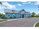 Charming blue building with a metal roof and covered entrance, surrounded by manicured landscaping at 5502 Limelight Dr, Apollo Beach, FL 33572