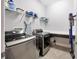 Well-organized laundry room featuring modern stainless-steel machines and ample shelving and countertop space at 5502 Limelight Dr, Apollo Beach, FL 33572