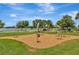 Outdoor fitness area features exercise equipment surrounded by lush greenery and a serene lake backdrop at 5502 Limelight Dr, Apollo Beach, FL 33572