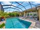 Private screened-in pool area with a refreshing in-ground pool, lounge chairs, and outdoor dining set at 5502 Limelight Dr, Apollo Beach, FL 33572