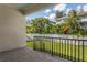 Outdoor view from a covered back porch featuring lush green grass and tropical landscaping at 3611 E Renellie Cir, Tampa, FL 33629