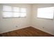 Spacious bedroom with wood-look floors and two windows at 4254 96Th N Ter # Two, Pinellas Park, FL 33782