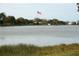 Scenic lake view featuring a large American flag and park amenities at 4254 96Th N Ter # Two, Pinellas Park, FL 33782