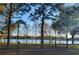 Picturesque lake view from behind a wooden fence and tall trees at 4254 96Th N Ter # Two, Pinellas Park, FL 33782