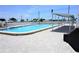 Community swimming pool with a shaded seating area and brick pavers at 4254 96Th N Ter # Two, Pinellas Park, FL 33782