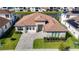 Modern home with a light-colored facade and paver driveway at 8731 Sanders Tree Loop, Wesley Chapel, FL 33545