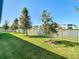 Landscaped backyard with a large green lawn at 8731 Sanders Tree Loop, Wesley Chapel, FL 33545