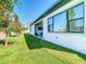 Spacious backyard with covered patio and lush green lawn at 8731 Sanders Tree Loop, Wesley Chapel, FL 33545