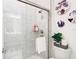 Clean bathroom with a walk-in shower and white tile at 8731 Sanders Tree Loop, Wesley Chapel, FL 33545
