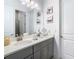 Bathroom with double vanity, gray cabinets, and white countertops at 8731 Sanders Tree Loop, Wesley Chapel, FL 33545