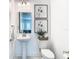 Clean and modern bathroom with pedestal sink and marble floor at 8731 Sanders Tree Loop, Wesley Chapel, FL 33545