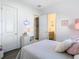 Spacious bedroom with a bed, dresser, and en-suite bathroom at 8731 Sanders Tree Loop, Wesley Chapel, FL 33545