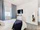Serene bedroom with a bed, dresser, and floor-to-ceiling mirror at 8731 Sanders Tree Loop, Wesley Chapel, FL 33545
