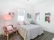 Cozy bedroom with a bed, chair, and various wall decorations at 8731 Sanders Tree Loop, Wesley Chapel, FL 33545