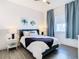 Bright bedroom with a queen bed, nightstands, and ample closet space at 8731 Sanders Tree Loop, Wesley Chapel, FL 33545