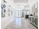 Elegant foyer with marble floors and modern artwork at 8731 Sanders Tree Loop, Wesley Chapel, FL 33545