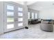 Bright and spacious entryway with double doors and a view into the living room at 8731 Sanders Tree Loop, Wesley Chapel, FL 33545