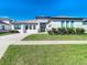 A modern, single-story home with a tiled driveway and landscaped front yard at 8731 Sanders Tree Loop, Wesley Chapel, FL 33545