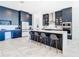 Modern kitchen with navy blue cabinets and a large island at 8731 Sanders Tree Loop, Wesley Chapel, FL 33545