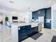 Modern kitchen with navy cabinets, quartz countertops, and stainless steel appliances at 8731 Sanders Tree Loop, Wesley Chapel, FL 33545