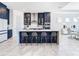 Spacious kitchen featuring navy blue cabinetry and an island with seating at 8731 Sanders Tree Loop, Wesley Chapel, FL 33545