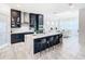 Modern kitchen with navy cabinets, quartz countertops, and stainless steel appliances at 8731 Sanders Tree Loop, Wesley Chapel, FL 33545