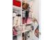 Well-organized linen closet with numerous pillows and blankets at 8731 Sanders Tree Loop, Wesley Chapel, FL 33545