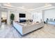 Open living room with sectional sofa, large TV, and marble floors at 8731 Sanders Tree Loop, Wesley Chapel, FL 33545