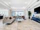 Spacious living area with access to the backyard and modern kitchen at 8731 Sanders Tree Loop, Wesley Chapel, FL 33545