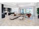 Open concept living room with modern kitchen and backyard view at 8731 Sanders Tree Loop, Wesley Chapel, FL 33545