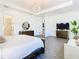 Spacious main bedroom with wood dresser and ensuite bathroom at 8731 Sanders Tree Loop, Wesley Chapel, FL 33545