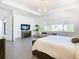 Main bedroom with sitting area, large windows, and a king bed at 8731 Sanders Tree Loop, Wesley Chapel, FL 33545