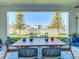 Covered patio with outdoor dining furniture and water view at 8731 Sanders Tree Loop, Wesley Chapel, FL 33545