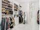 Large walk-in Primary closet with ample shelving and hanging space at 8731 Sanders Tree Loop, Wesley Chapel, FL 33545