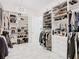 Spacious Primary closet with custom built-ins and mirrored doors at 8731 Sanders Tree Loop, Wesley Chapel, FL 33545