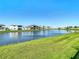 Serene waterfront view with lush green landscaping at 8731 Sanders Tree Loop, Wesley Chapel, FL 33545