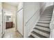 Hallway featuring stairs and a view into a bathroom and closet at 12613 Longstone Ct, New Port Richey, FL 34655