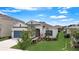 One-story home with blue garage door and well-manicured lawn at 5521 Limelight Dr, Apollo Beach, FL 33572