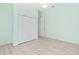 Light green bedroom with wood flooring at 7925 Royal Queensland Way, Lakewood Ranch, FL 34202