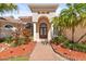 Columns, double door entry, and meticulously maintained landscaping at 7925 Royal Queensland Way, Lakewood Ranch, FL 34202
