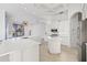 Modern kitchen with white cabinets and large island at 7925 Royal Queensland Way, Lakewood Ranch, FL 34202