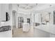 Modern kitchen with white cabinets and large island at 7925 Royal Queensland Way, Lakewood Ranch, FL 34202