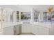 Modern kitchen with white cabinets and island overlooking pool at 7925 Royal Queensland Way, Lakewood Ranch, FL 34202