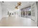 Open living room with high ceilings and access to patio at 7925 Royal Queensland Way, Lakewood Ranch, FL 34202