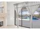 Living room with fireplace and sliding doors to pool at 7925 Royal Queensland Way, Lakewood Ranch, FL 34202